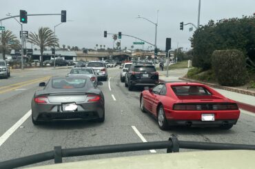 I stopped behind an [Aston Martin Vanquish] and [Ferrari 348] at a red light near my office… bonus if you can guess my vehicle