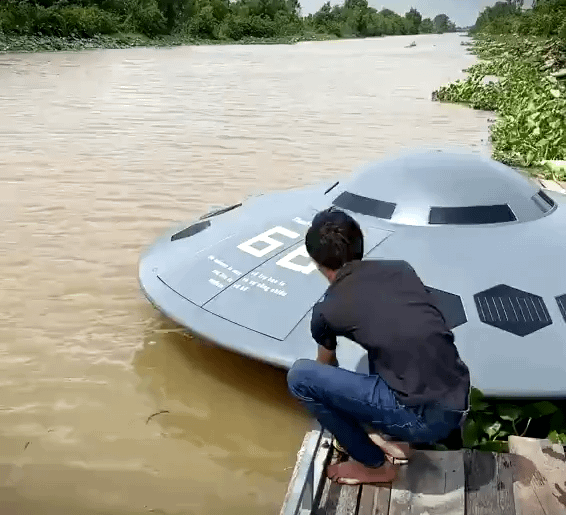 A Vietnamese YouTuber Thánh Chế casually launching his UFO shaped boat into the river