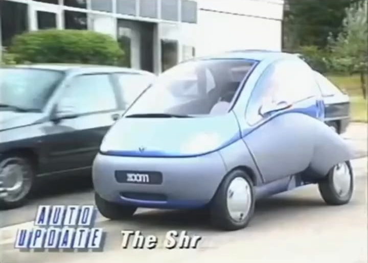 The 1992 Renault Zoom was an electric city concept car with a retractable wheelbase and compact design for tight urban spaces. It featured innovative beetle-wing doors and a recyclable 25kW engine, emphasizing both maneuverability and eco-friendliness.