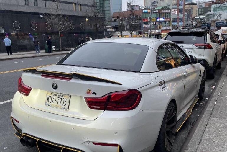 [BMW M4] with the most unhinged “up”badging I’ve ever seen.