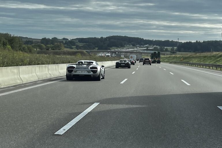 A buch of [Porsche Carrera GT] and [Porsche 918]s on a German Highway